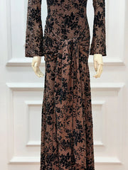 Long brown dress with black floral pattern on a mannequin against a white background