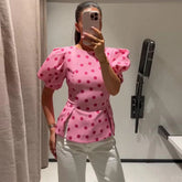 Pink polka dot puff sleeve peplum top front view