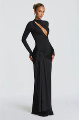 Woman wearing a black evening gown with a plunging neckline
