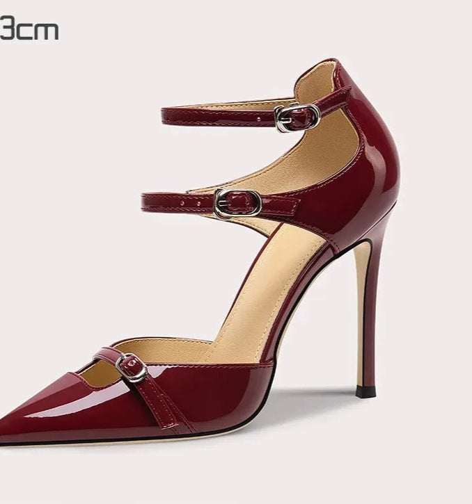 Red high-heeled shoe with a strap on a white background