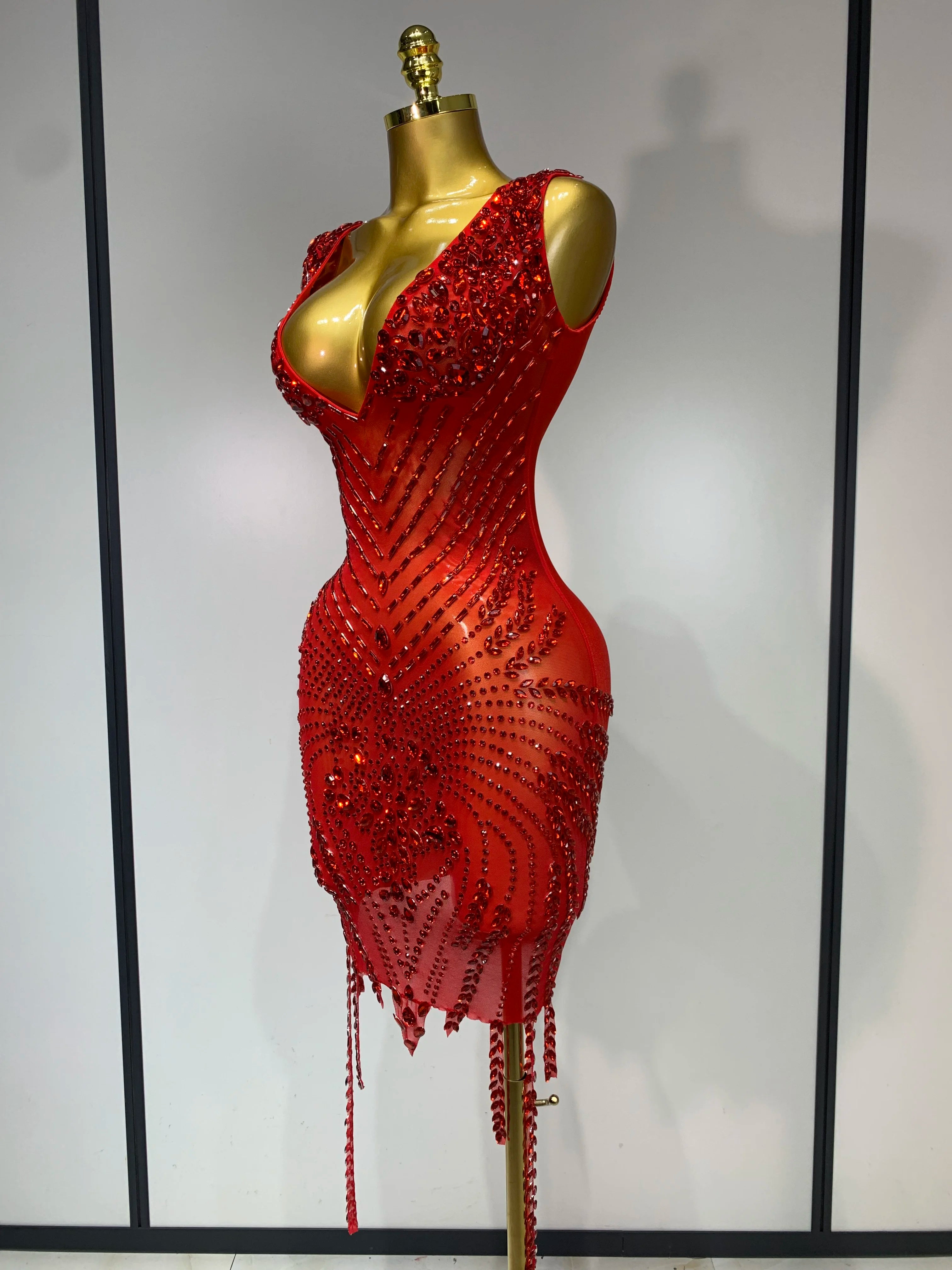 Red beaded dress on a mannequin against a neutral background