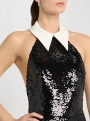 Black sequin dress with white collar worn by a model on a plain background