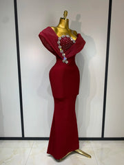 Close-up of the embellished neckline on a burgundy gown