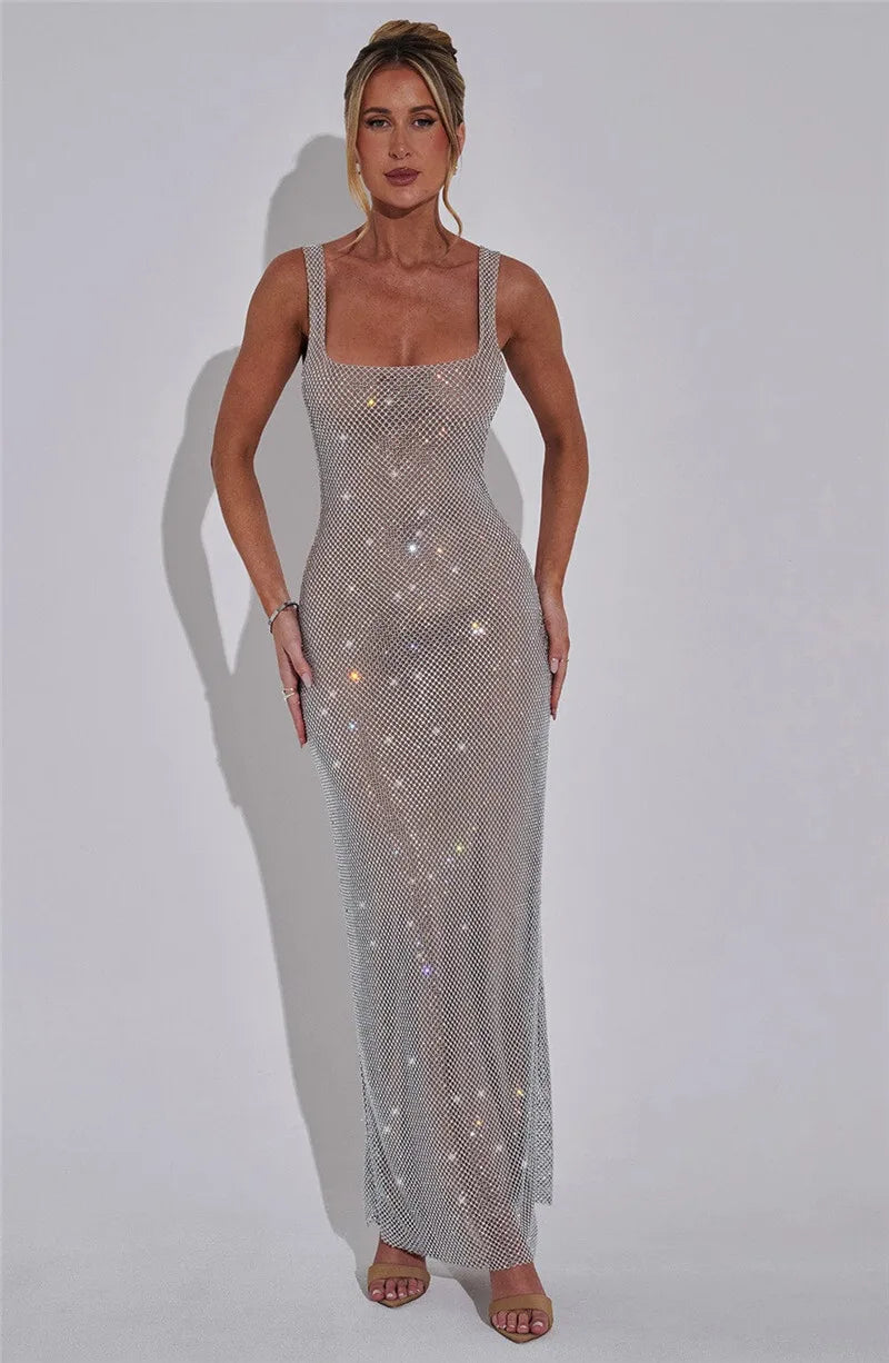 Woman wearing a sparkly silver dress against a white background
