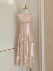 Pink sequin dress on a mannequin against a neutral wall.