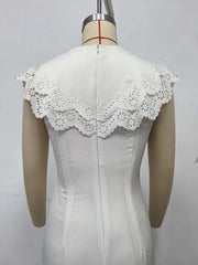 White lace-trimmed top on a mannequin against a plain background