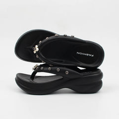 Stacked black platform thong sandals with silver metal stud embellishments.