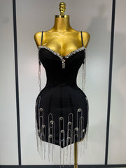 Black dress with silver embellishments on a mannequin against a neutral background