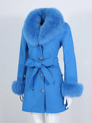 Blue coat with fur trim on a mannequin against a white background
