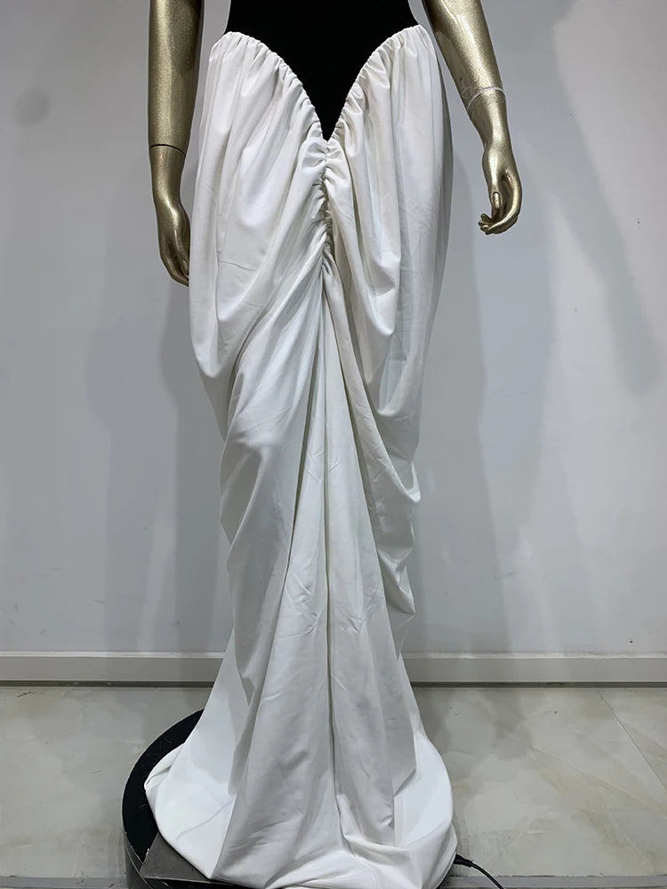 Mannequin wearing a white satin gown with a black bodice against a plain background