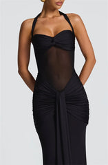 Black evening gown with sheer overlay on a white background
