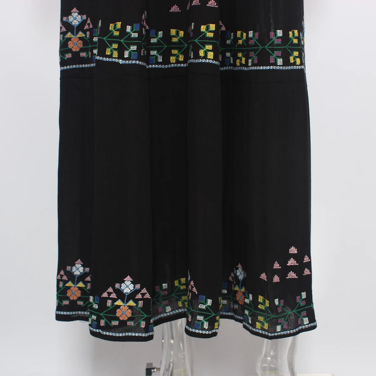 Black dress with colorful geometric embroidery