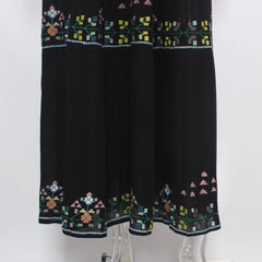 Black dress with colorful geometric embroidery