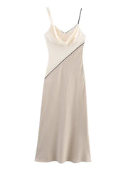 Beige dress with black accents on a white background