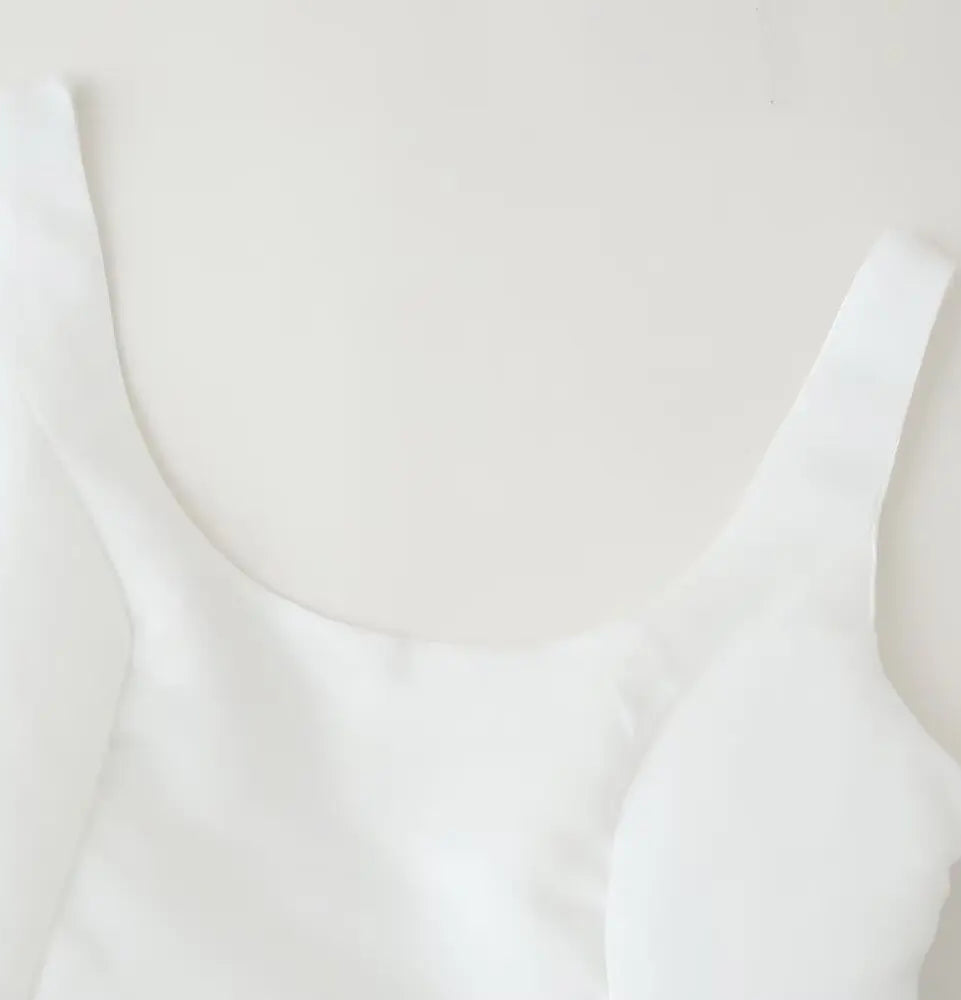 White tank top on a light beige background