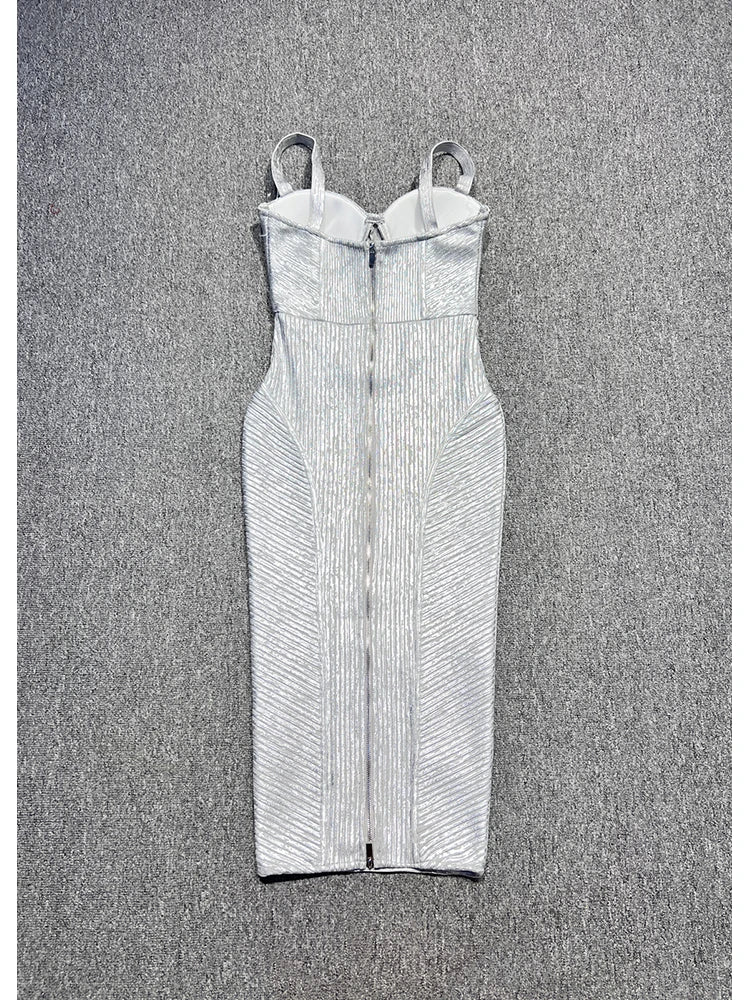 White strapless dress with ruched details on a textured gray background