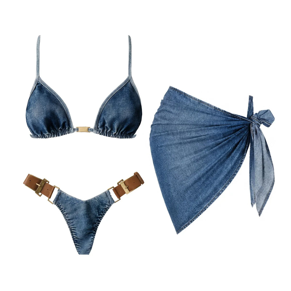 Denim triangle bikini top with gold hardware and matching low-rise bottoms with belt details, alongside a denim wrap skirt.