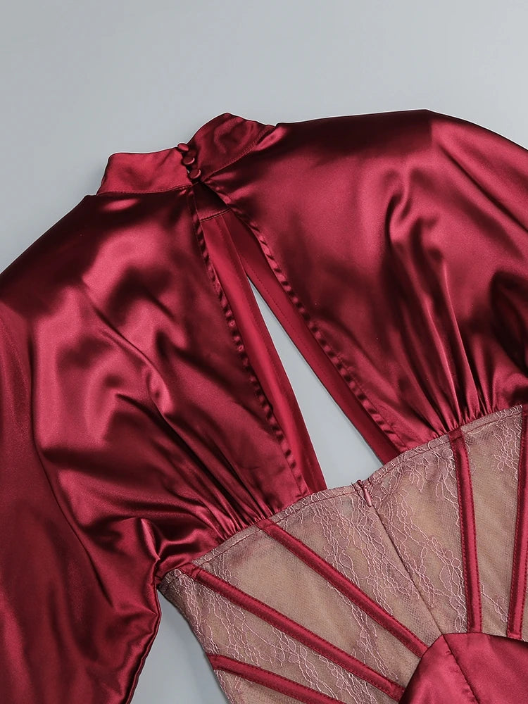 Red satin garment with lace detailing on a gray background