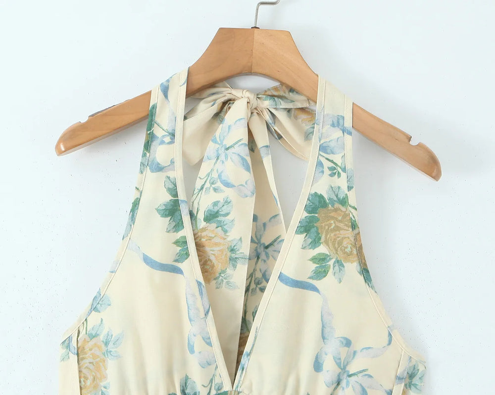 Floral-patterned halter top on a wooden hanger against a white background