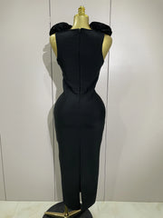 Black evening gown on a mannequin against a white background