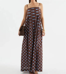Model wearing a polka dot spaghetti strap maxi dress.