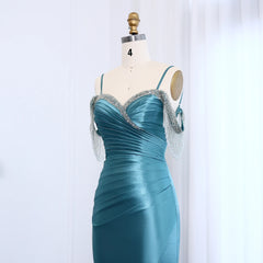 Teal evening gown with beaded details on a mannequin against a white background