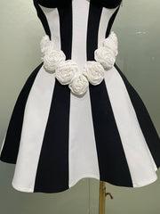 Black and white striped dress with floral details on a mannequin against a neutral background