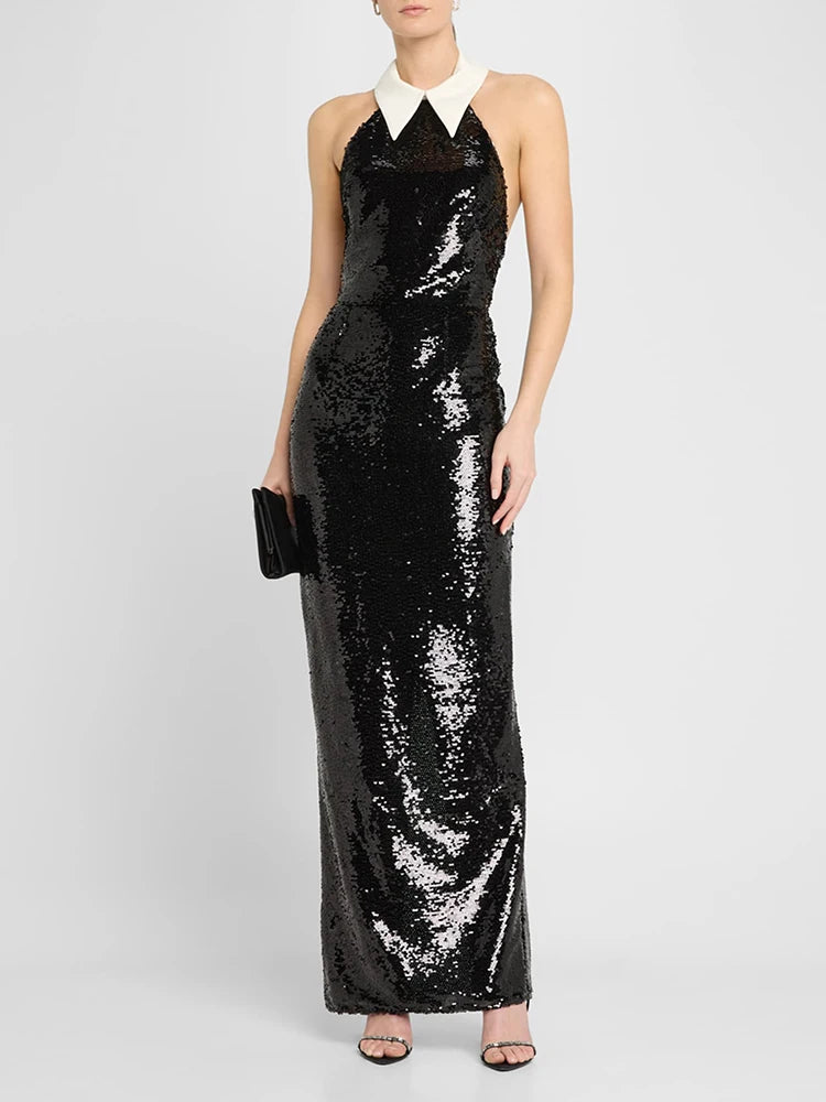 Black sequin dress with a white collar worn by a model on a white background