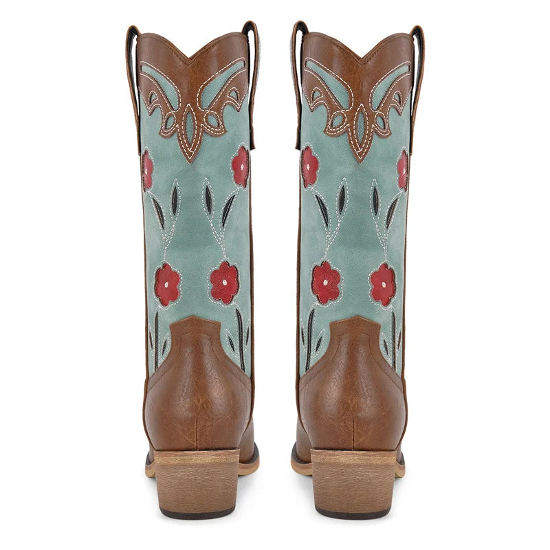 Pair of cowboy boots with floral design on a white background