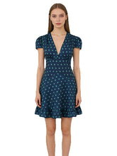 A-line mini dress with V-neck and puff sleeves on a model