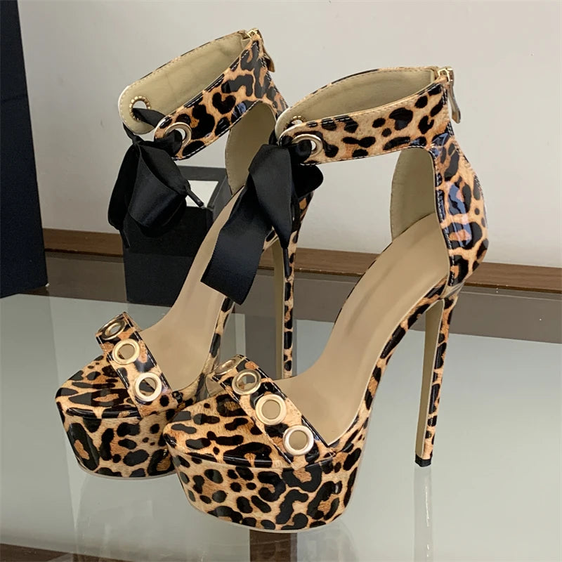 Leopard print platform stiletto lace-up sandals with metal eyelets and ribbon ties.