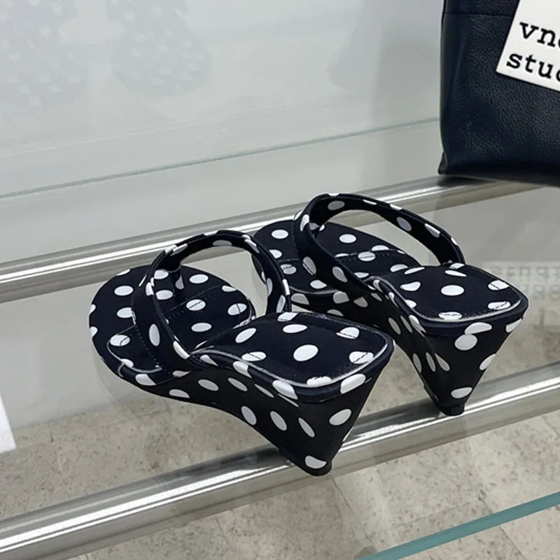 Black polka dot wedge flip-flops from the side