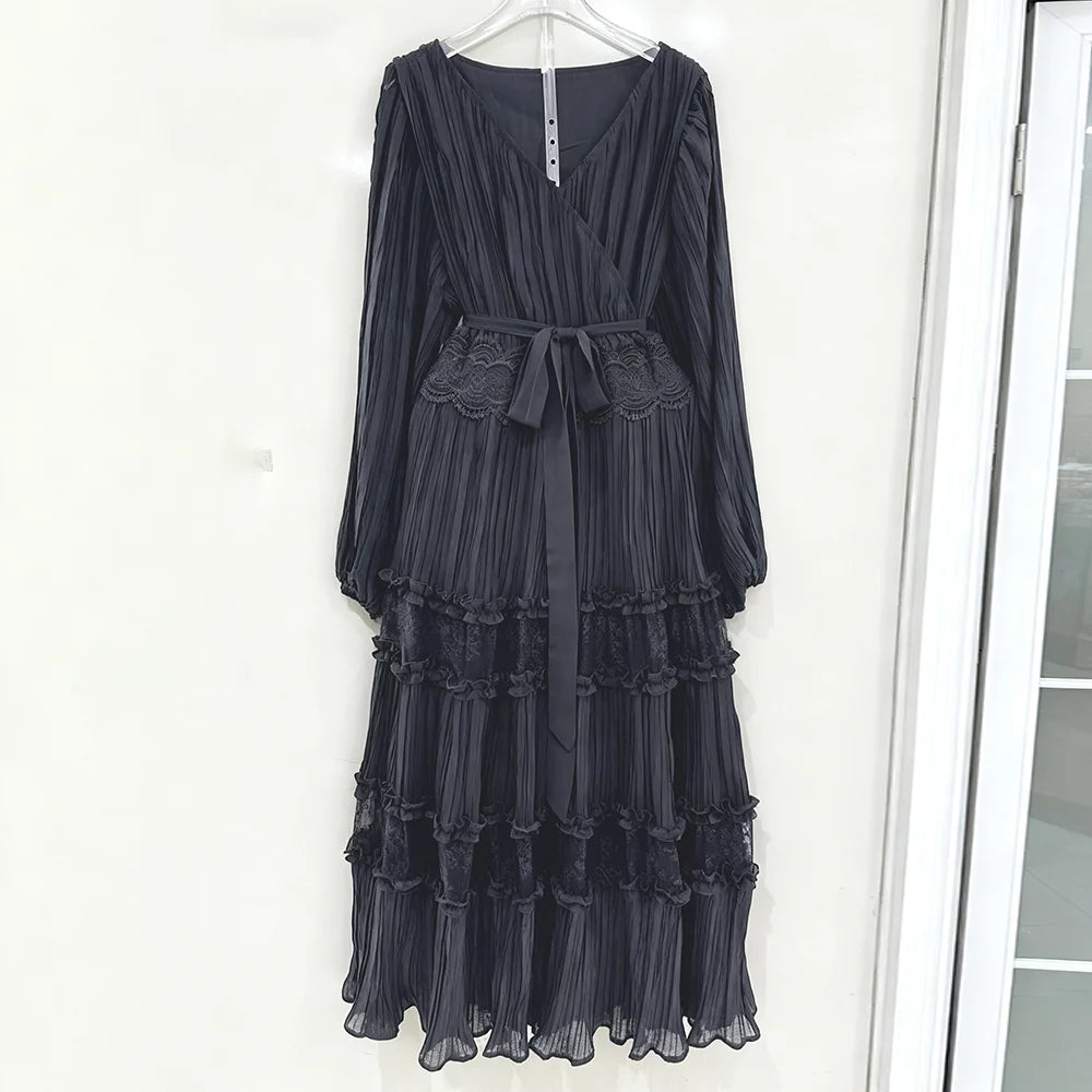 Black ruffled dress hanging on a white door