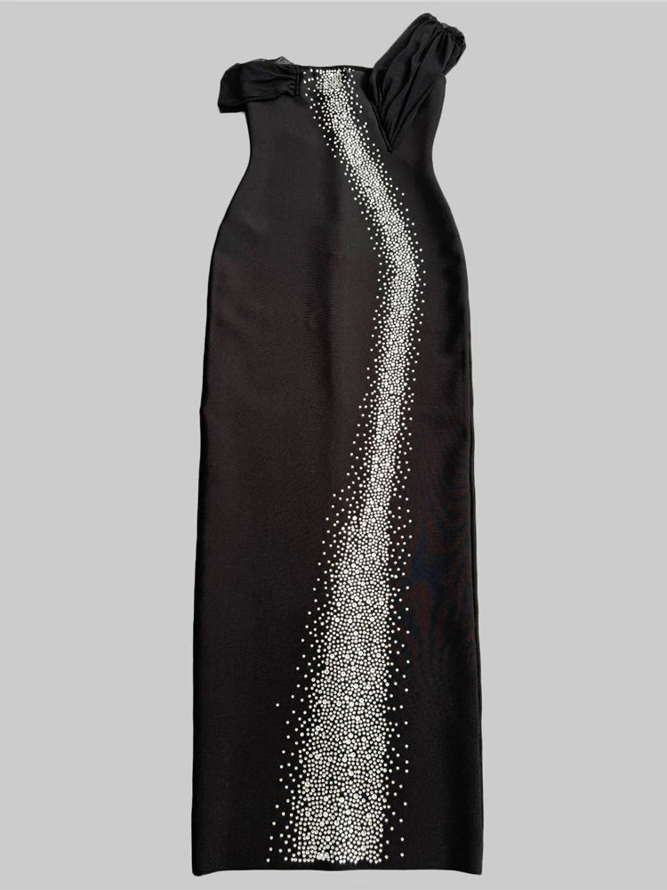 Black evening gown with silver embellishments on a gray background