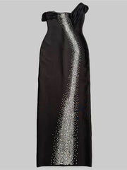Black evening gown with silver embellishments on a gray background