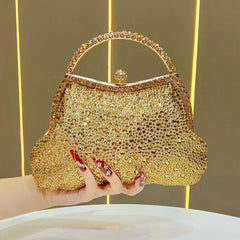 Gold crystal-encrusted top handle clutch bag