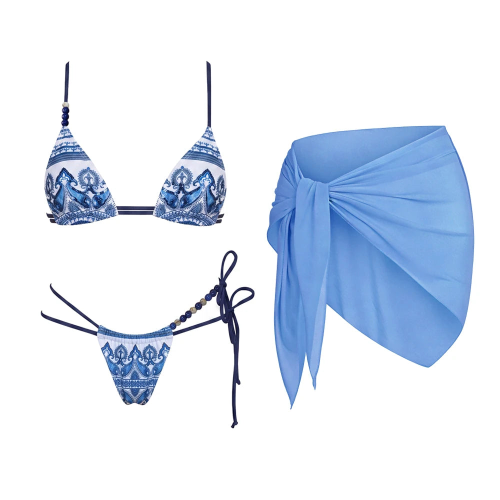 Blue print triangle bikini with beaded embellishments and a matching wrap skirt.
