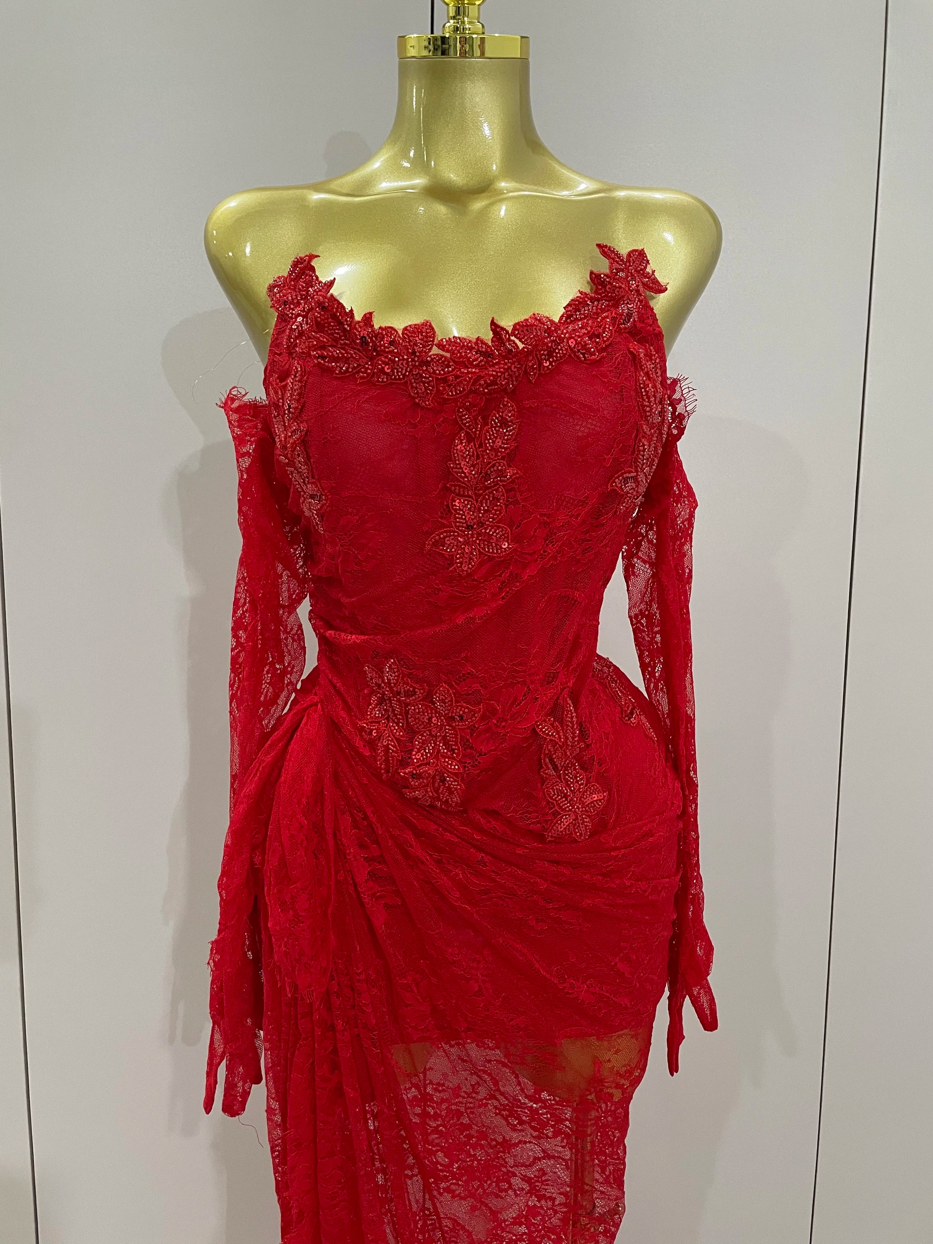 Red lace dress on a mannequin against a white background