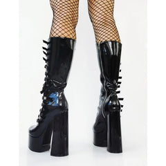 Black platform boots with high heels and decorative elements on a white background