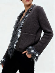 Dark gray cardigan with feather and sequin details on a plain background