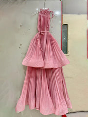 Pink pleated dress hanging