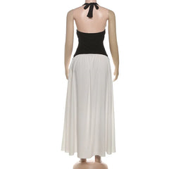 Black halter top and white skirt on a mannequin against a white background