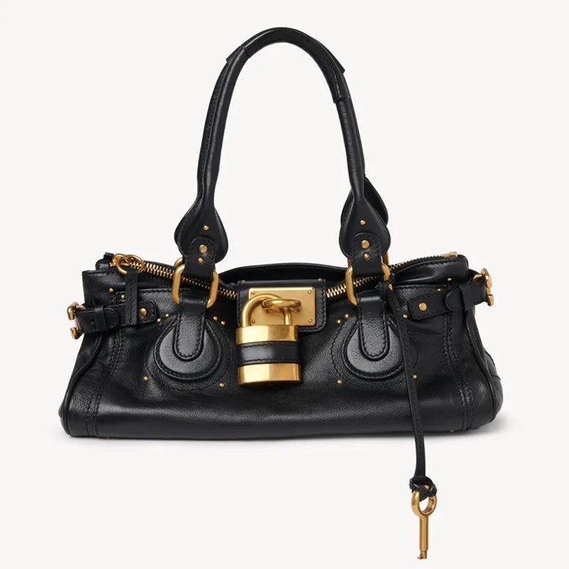black metallic satchel with gold clasp and top handle,