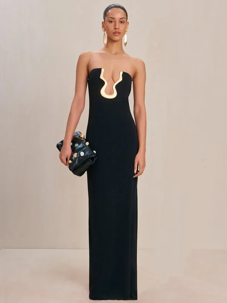 Strapless black maxi dress with gold neckline detail and a fitted silhouette.