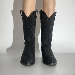 Model wearing pointed toe embellished western boots