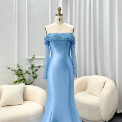 Mannequin wearing a light blue evening gown with lace details in a room with white walls and furniture.