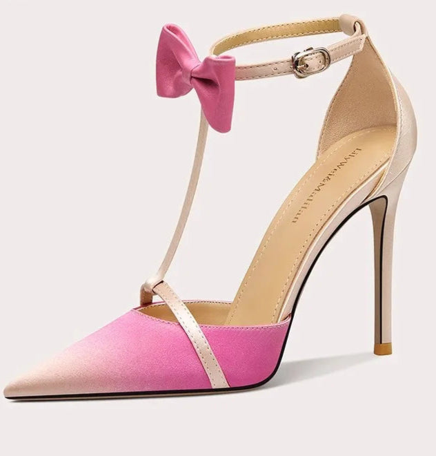 High-heeled shoe with a pink bow on a white background