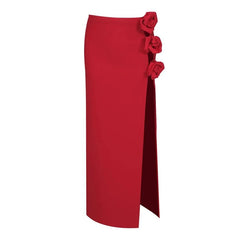 Red maxi skirt with floral embellishments and a high slit, isolated on white background