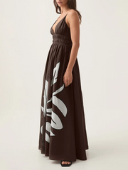 Side profile of a person wearing a brown floral print V-neck shirred empire waist maxi dress