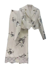 White outfit with floral patterns on a white background